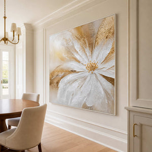 White-framed square floral artwork beside a wood breakfast table and cream upholstered dining chairs.