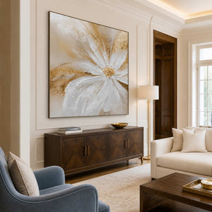 Grace in Bloom in a black frame above a wood cabinet, with a cream sofa and blue armchair in a welcoming living room.