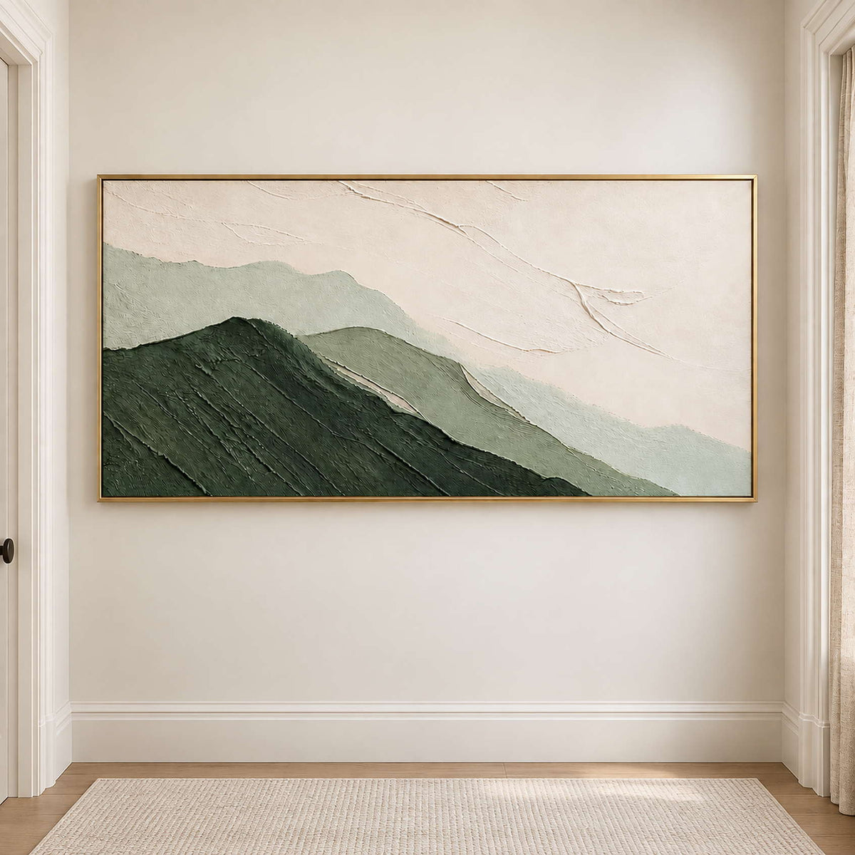Layered dark and pale green mountains beneath an ivory sky in a gold frame, displayed in a hallway.