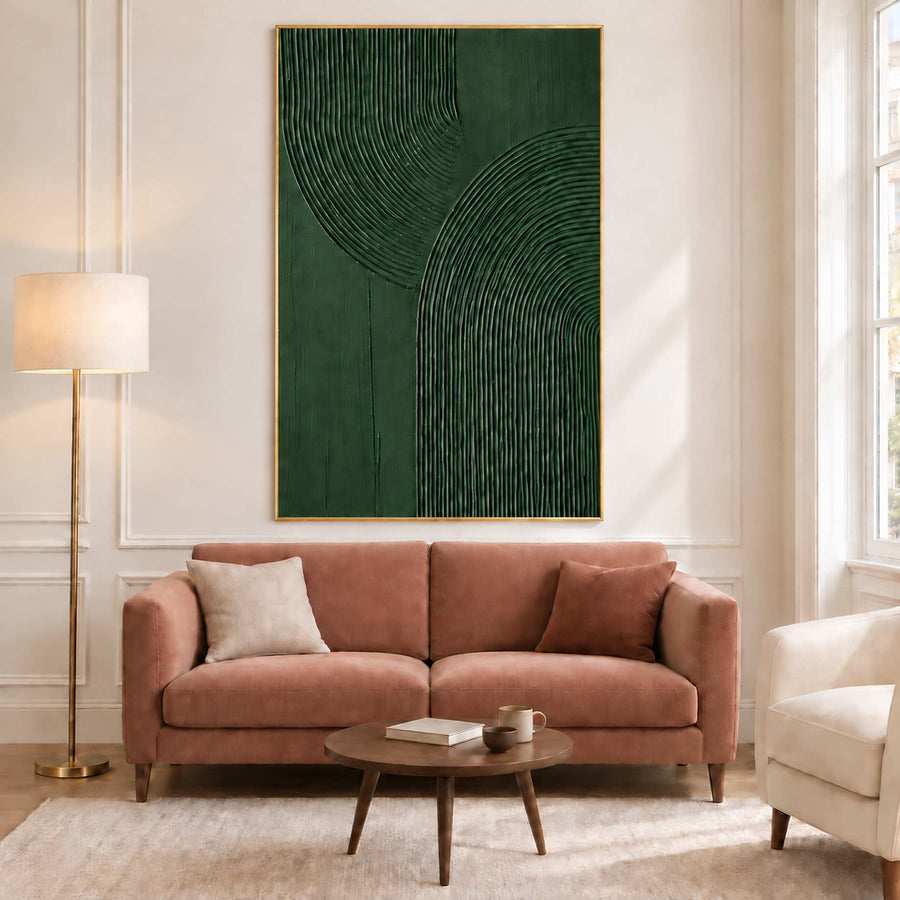 Deep green ridged artwork above a dusty pink sofa.