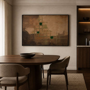 Modern brown abstract wall art in a black frame beside dining furniture.