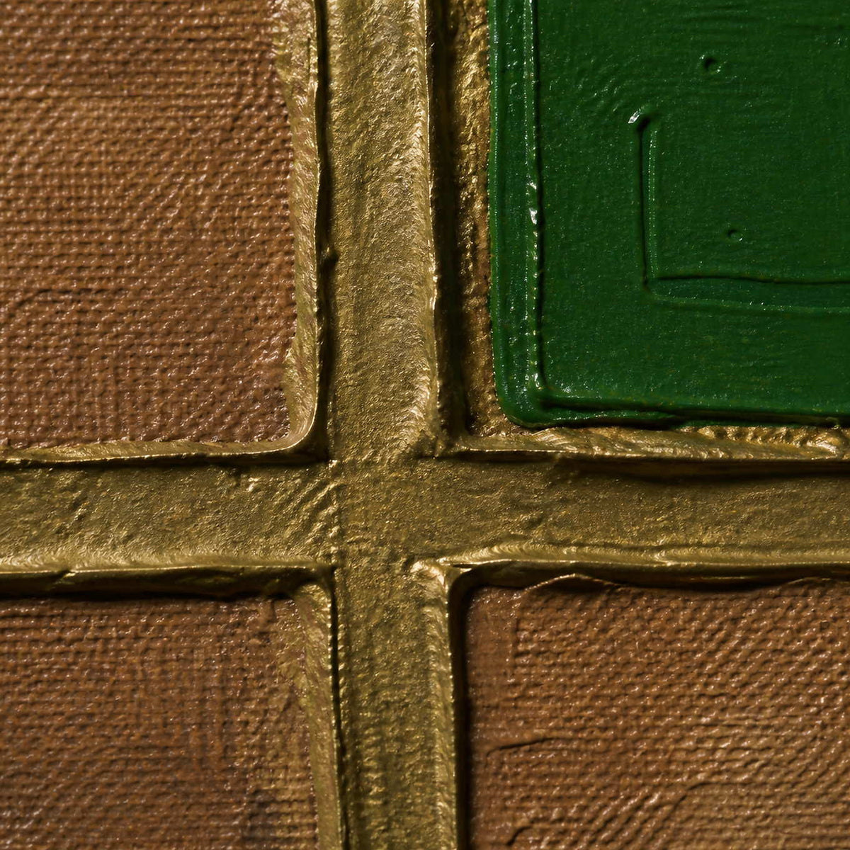 Close detail of raised gold grid lines and emerald green paint.