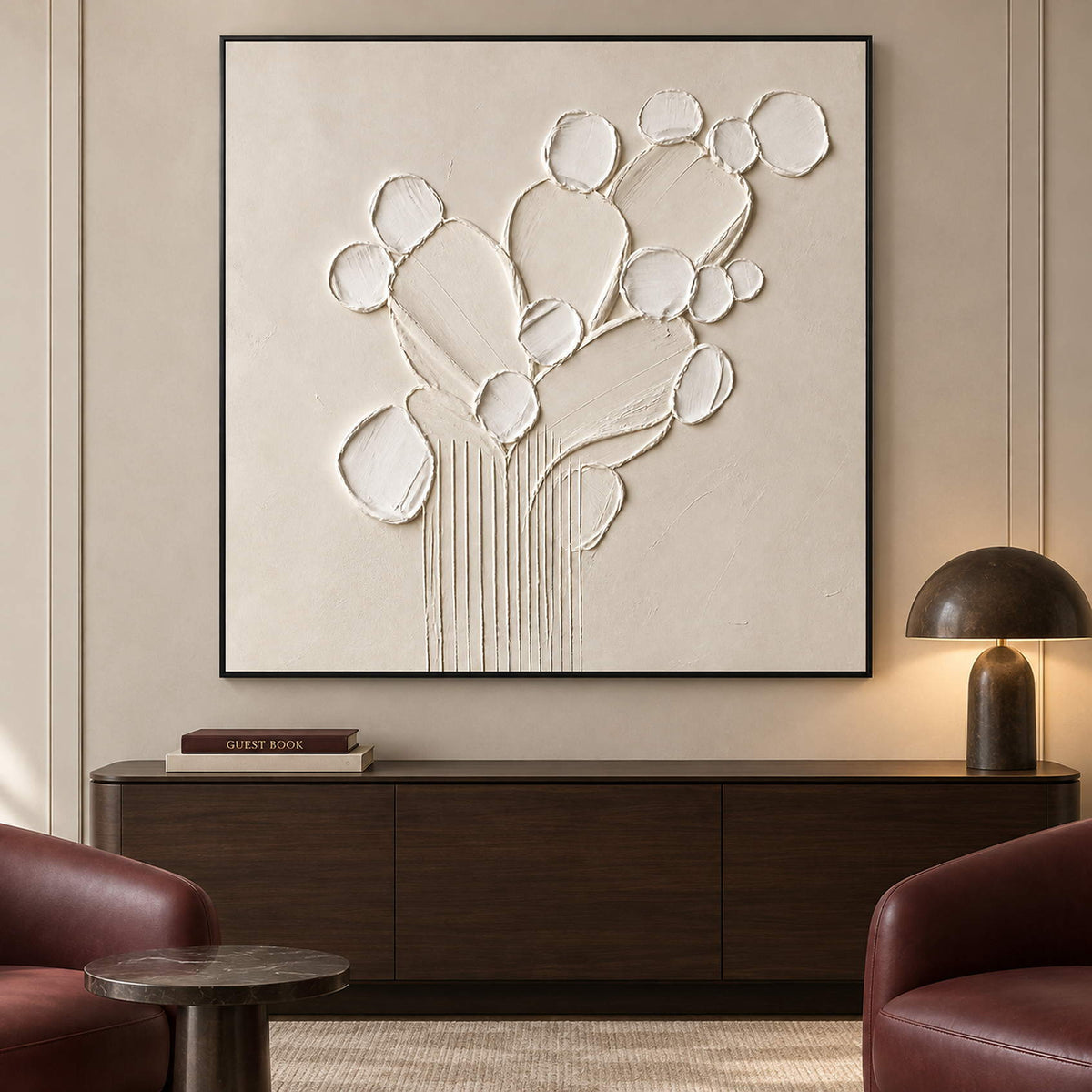 Sculptural warm white petals and leaves raised from a monochrome canvas, displayed in a lounge in a black frame.