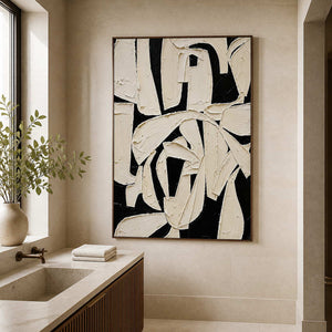 Wood framed ivory and black abstract artwork beside a stone bathroom vanity.