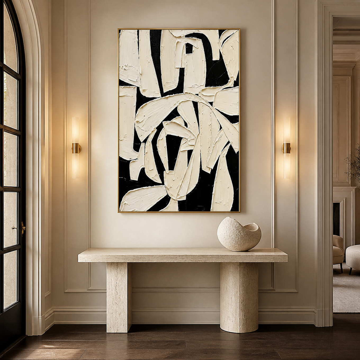 Gold framed abstract painting with overlapping ivory forms above a stone hallway console.