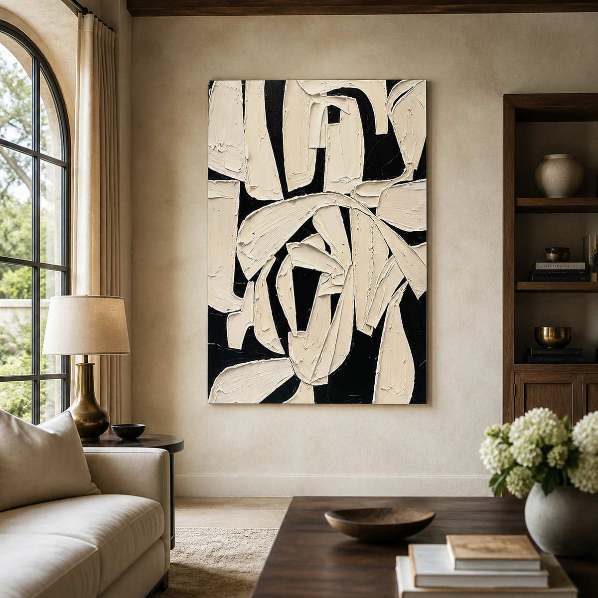 Frameless ivory and black abstract artwork with overlapping strokes beside a living room sofa.