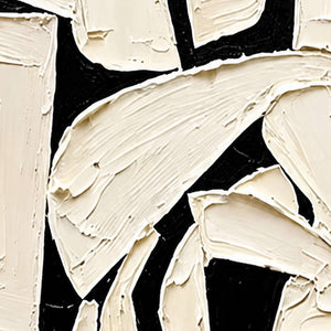 Close-up of raised ivory strokes, ridged edges, and black gaps in abstract artwork.