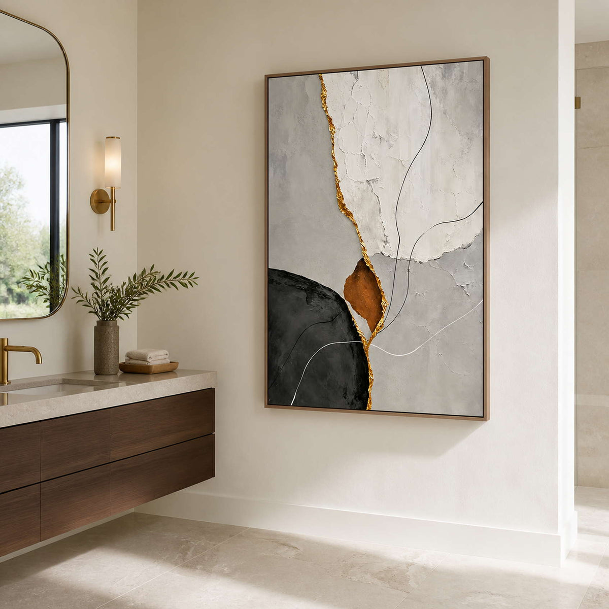 Wood framed neutral abstract artwork with a gold-toned seam beside a bathroom vanity.