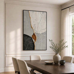 Black framed abstract artwork with fine curves above a wooden dining table.