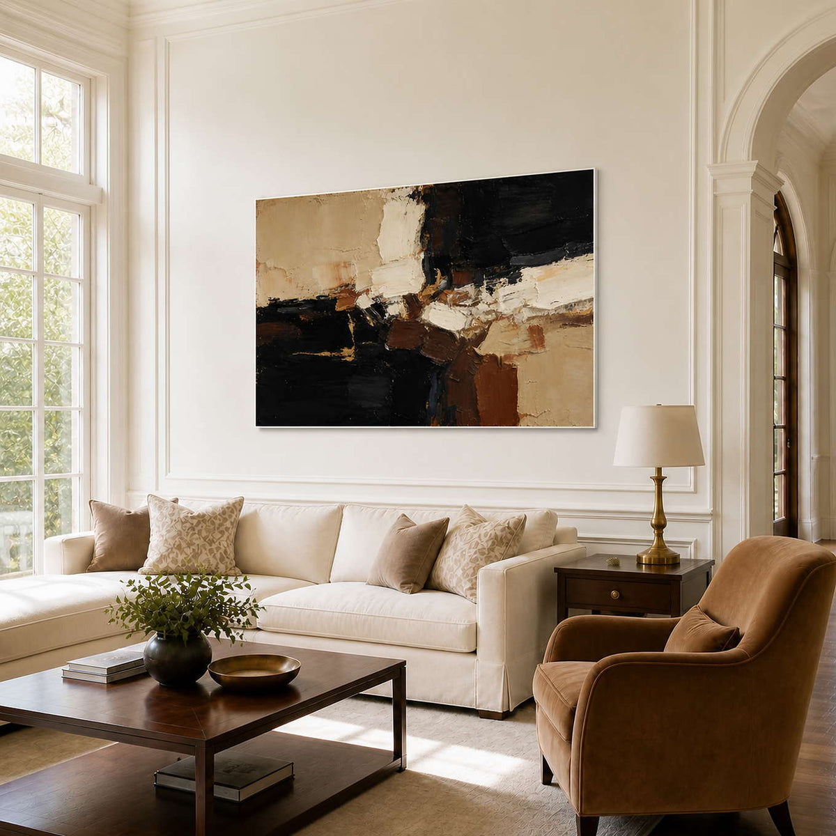 White framed black and cream abstract artwork above a neutral living room sofa.