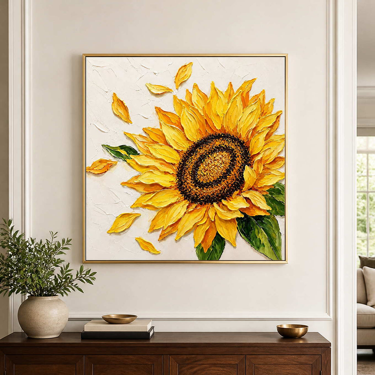 Gold-framed yellow sunflower painting above a wooden hallway console with a small vase of greenery.