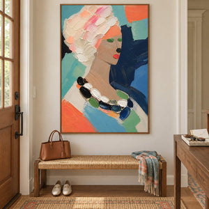 Colorful portrait painting of a woman with textured pale hair and a beaded necklace in a brown wood frame in an entryway.