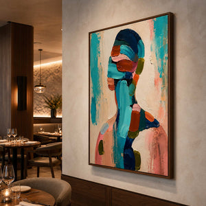 Textured figurative wall art displayed in a warm fine dining interior.