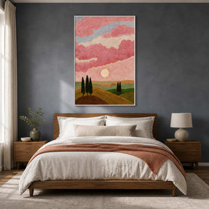 White framed painting of sunlit hills and pink clouds above a bedroom headboard.