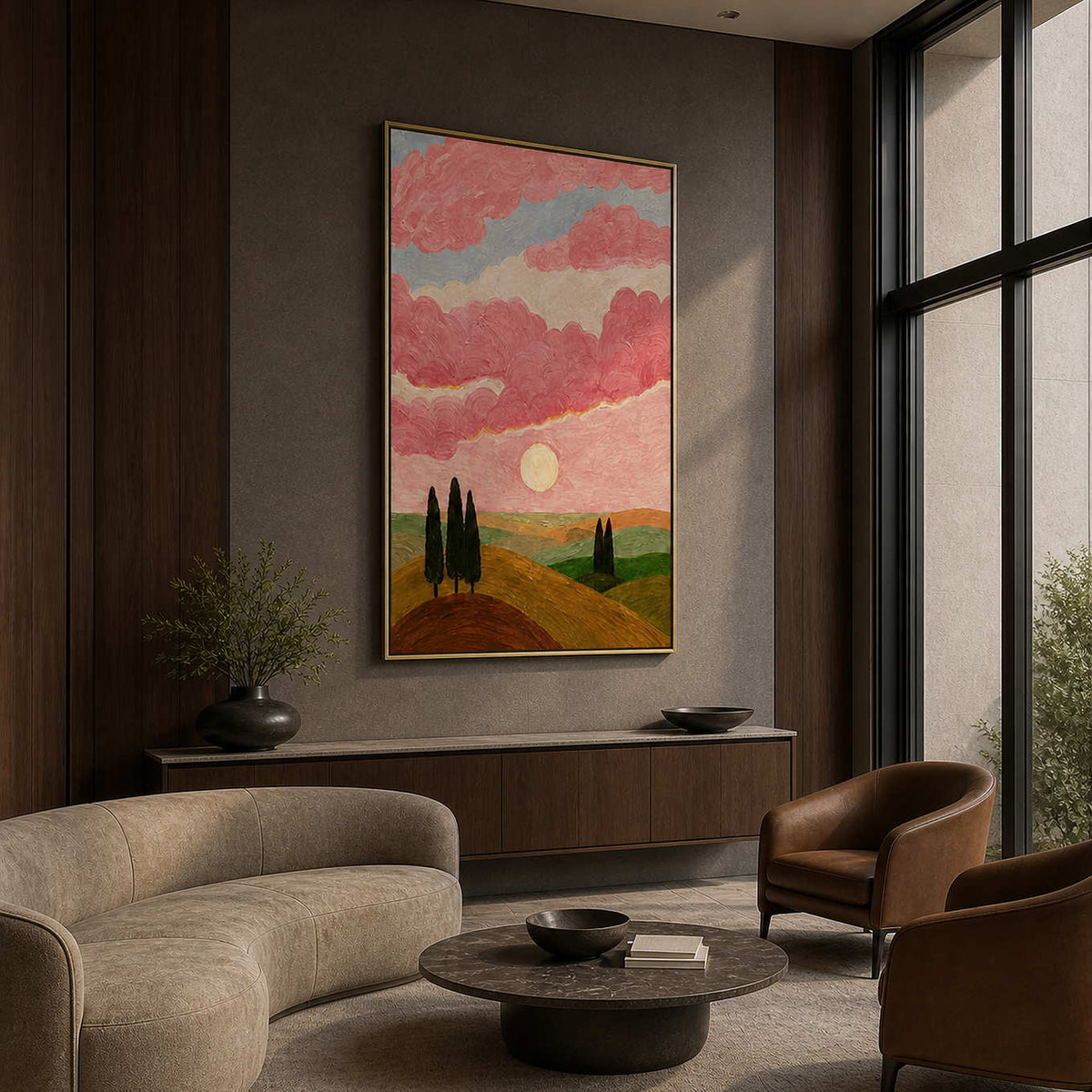 Gold framed pink cloud landscape displayed beside seating in a boutique hotel lobby.