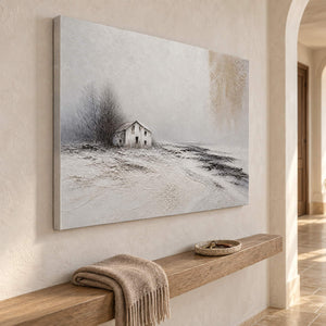 Winter landscape painting with a small house and dark trees beyond a snowy field without an outer frame in a hallway.