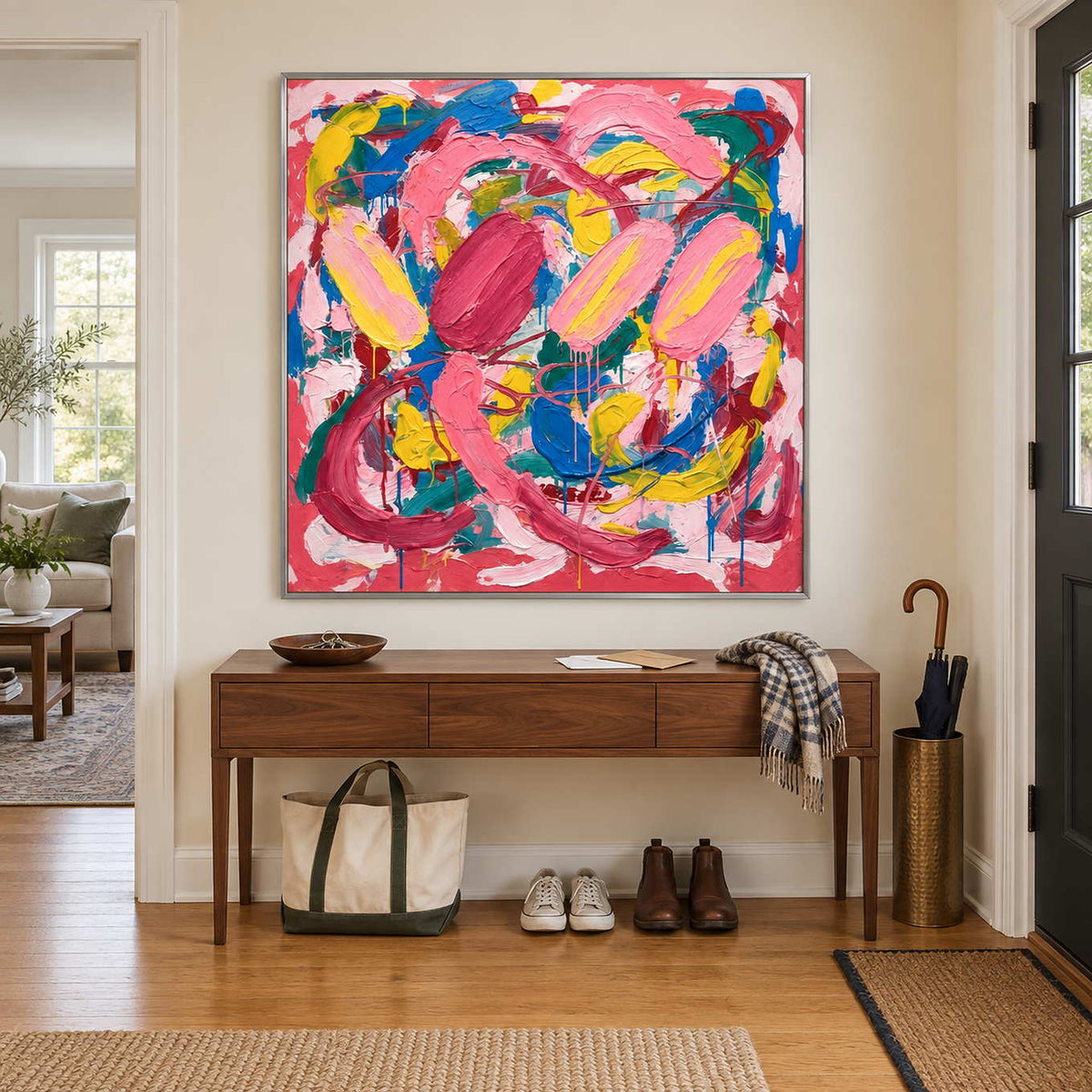 In Full Swing in a silver frame above a walnut console with a tote bag and shoes underneath.