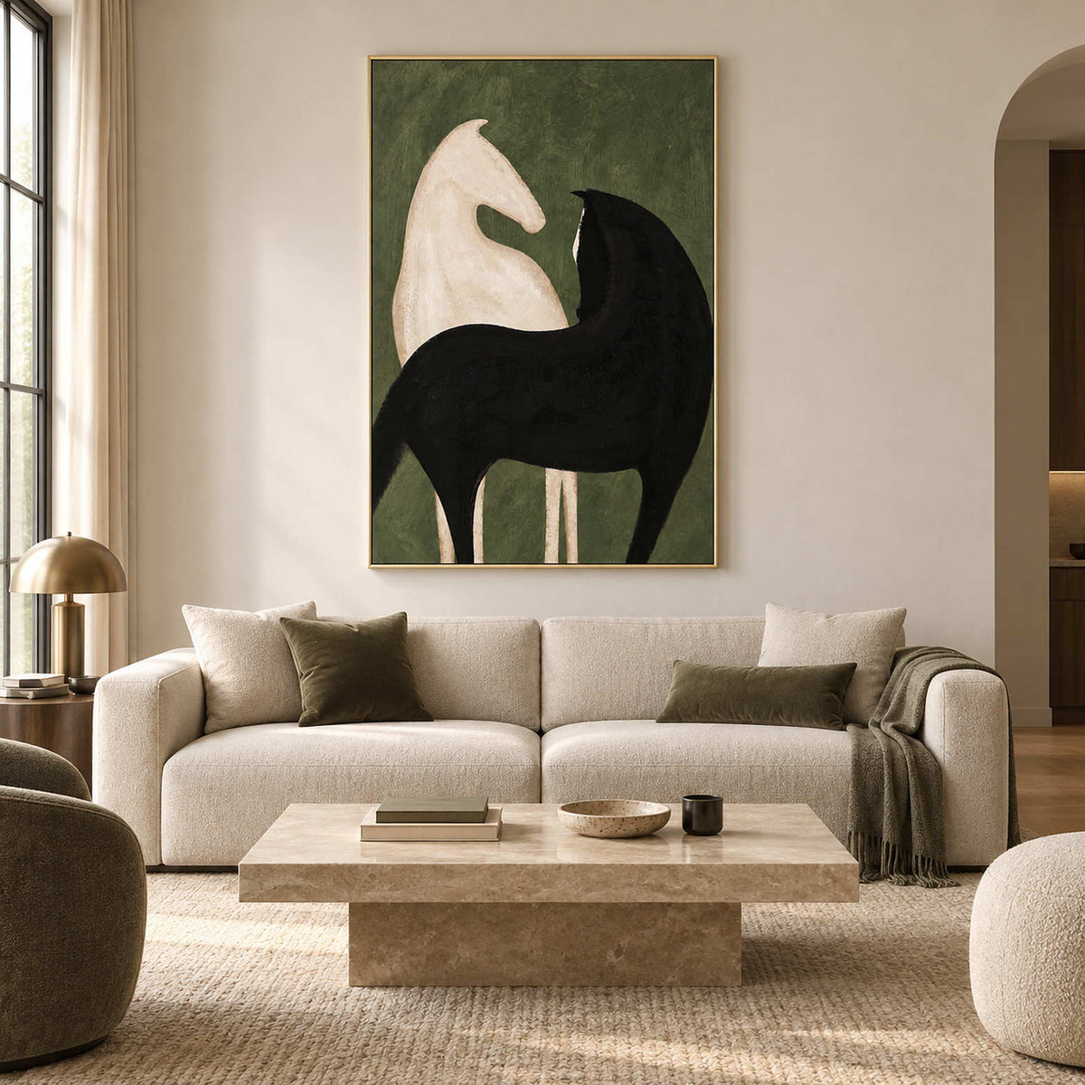 Black and cream horse artwork above a cream sofa with olive cushions.
