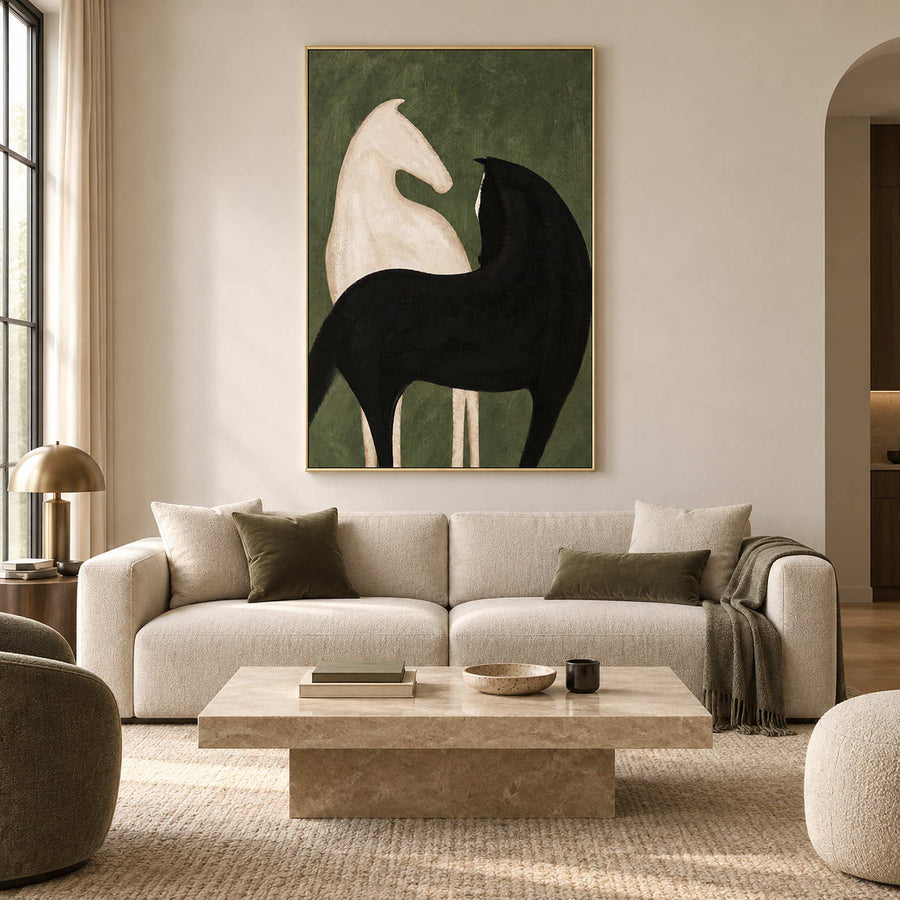 Black and cream horse artwork above a cream sofa with olive cushions.