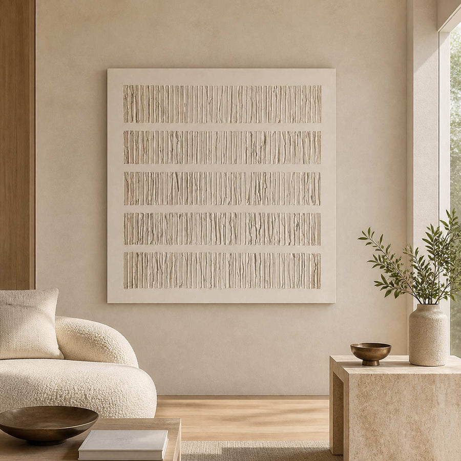 Frameless cream ridged abstract artwork beside a curved sofa in a neutral living room.