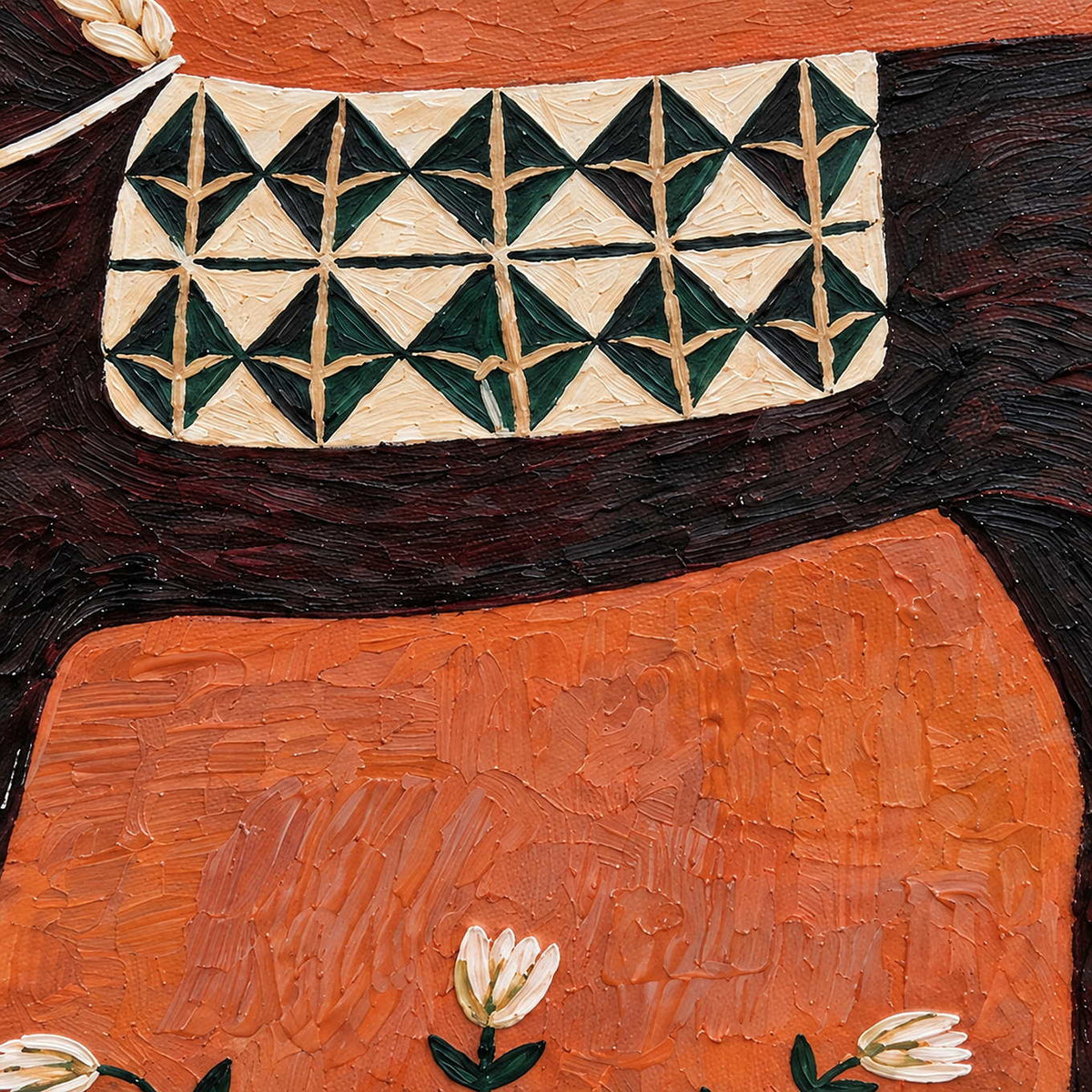Detail of cream-and-green saddlecloth patterns and orange textured paint.