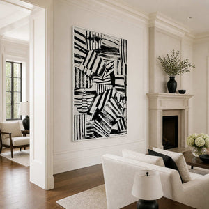 White-framed striped abstract wall art beside a fireplace in an elegant living room.