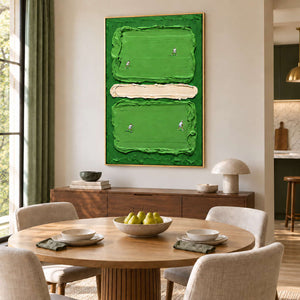 In the Swing in a gold frame above a wood sideboard beside a round dining table and cream chairs.