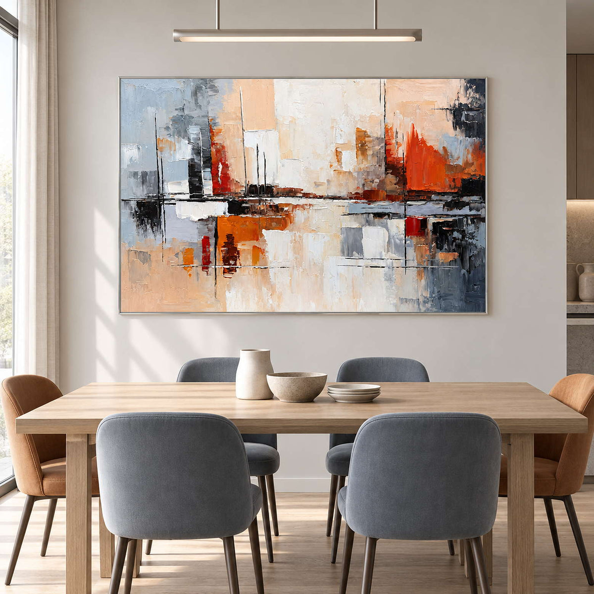 Gray and orange abstract painting above a wood dining table with blue-gray chairs.