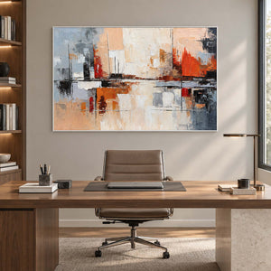 Geometric abstract painting behind a wood desk and brown office chair beside built-in shelves.
