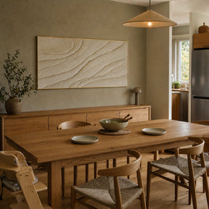 Neutral relief wall art displayed in a warm oak dining room.