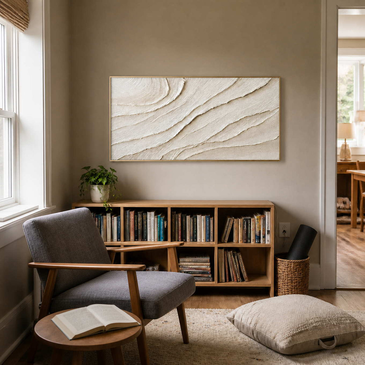 Neutral textured wall art displayed in a quiet reading nook.