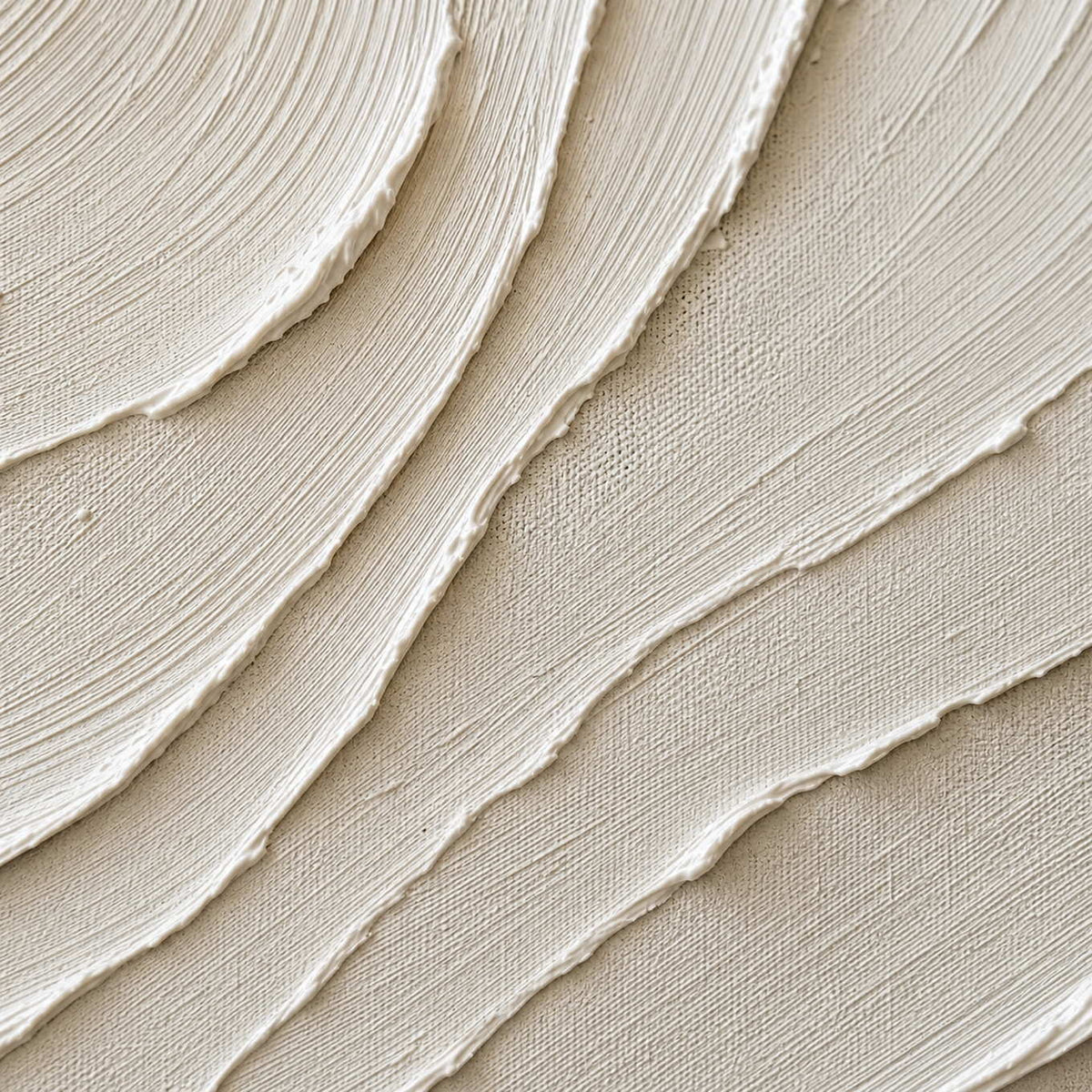 Close-up of layered ivory ridges and finely combed canvas texture.