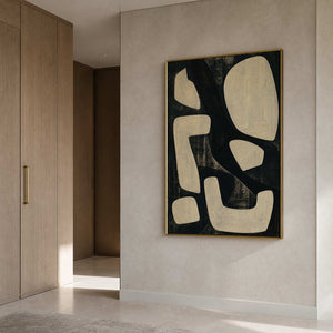 Vertical black and ivory wall art in a bathroom with a gold frame.