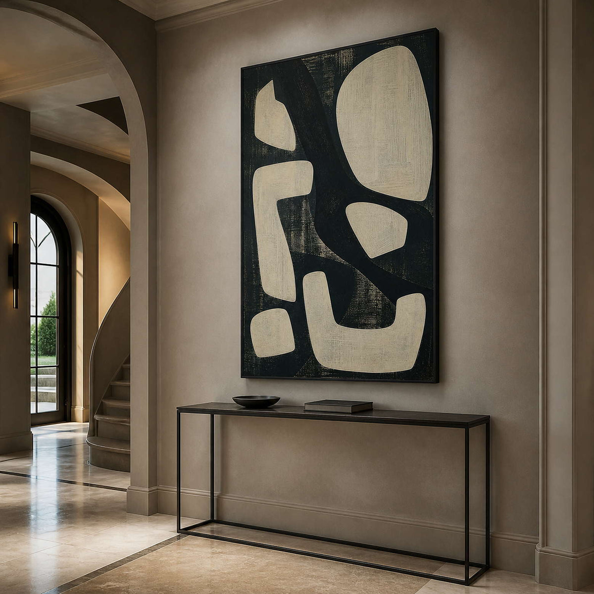 Graphic abstract wall art in an elegant entryway with a black frame.