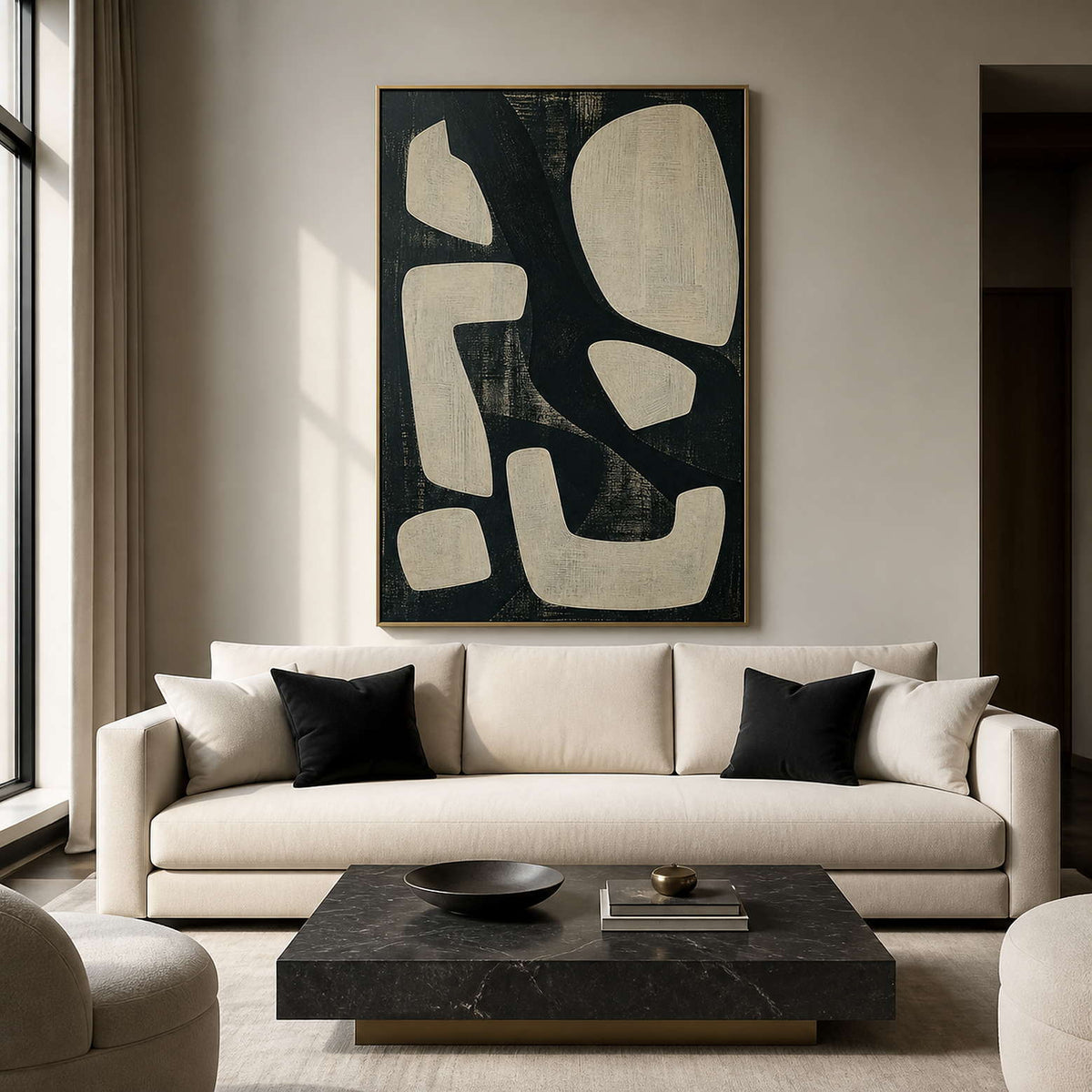 Modern black and ivory abstract wall art in a refined living room.