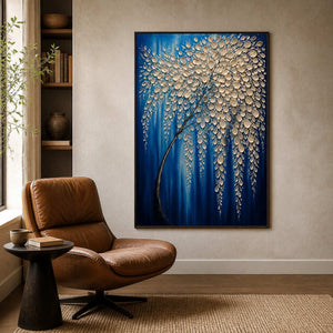Textured blue botanical wall art beside a caramel leather reading chair.
