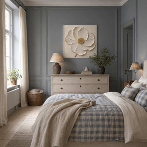 Textured ivory flower wall art displayed above a dresser in a serene bedroom.