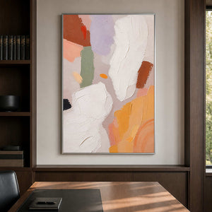 Warm minimalist wall art brings balance to a dark wood office.