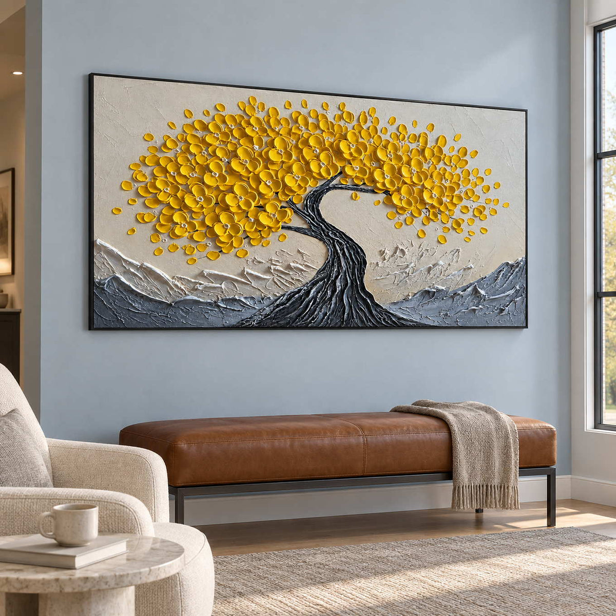 Black-framed yellow tree painting above a brown bench on a blue wall.