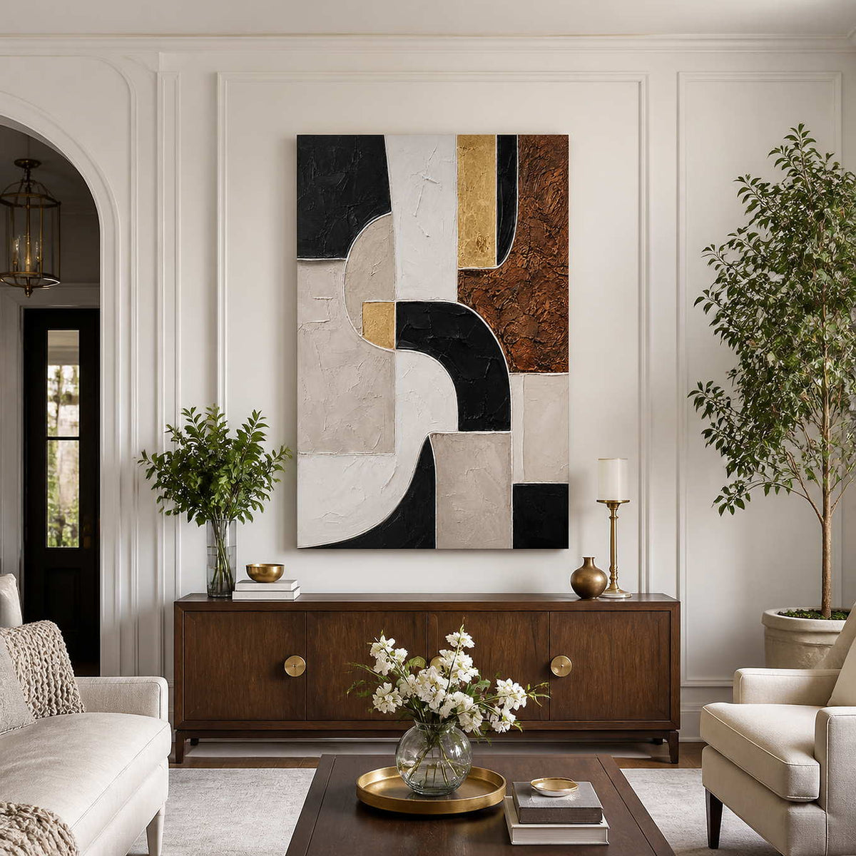 Frameless geometric artwork above a wooden sideboard between cream living room seats.