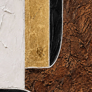 Close view of raised cream borders separating gold, black, and richly textured brown areas.