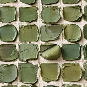 Close-up of Keeping a Little Spring revealing varied green paint squares, curled edges and palette-knife folds separated by cream gaps.