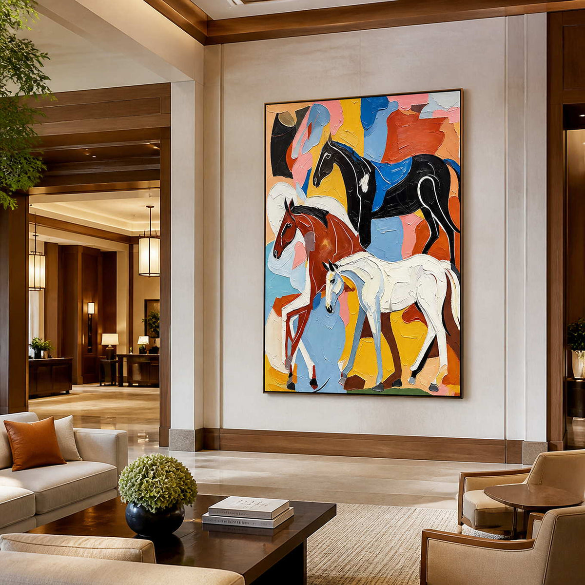 Black framed equestrian artwork showing three horses against vivid colors in a hotel lobby.