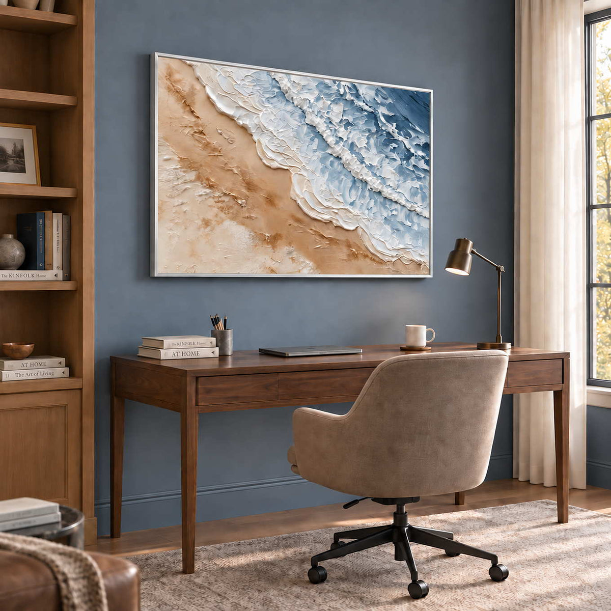 Kissing the Shore in a silver frame above a dark wood desk and taupe office chair.