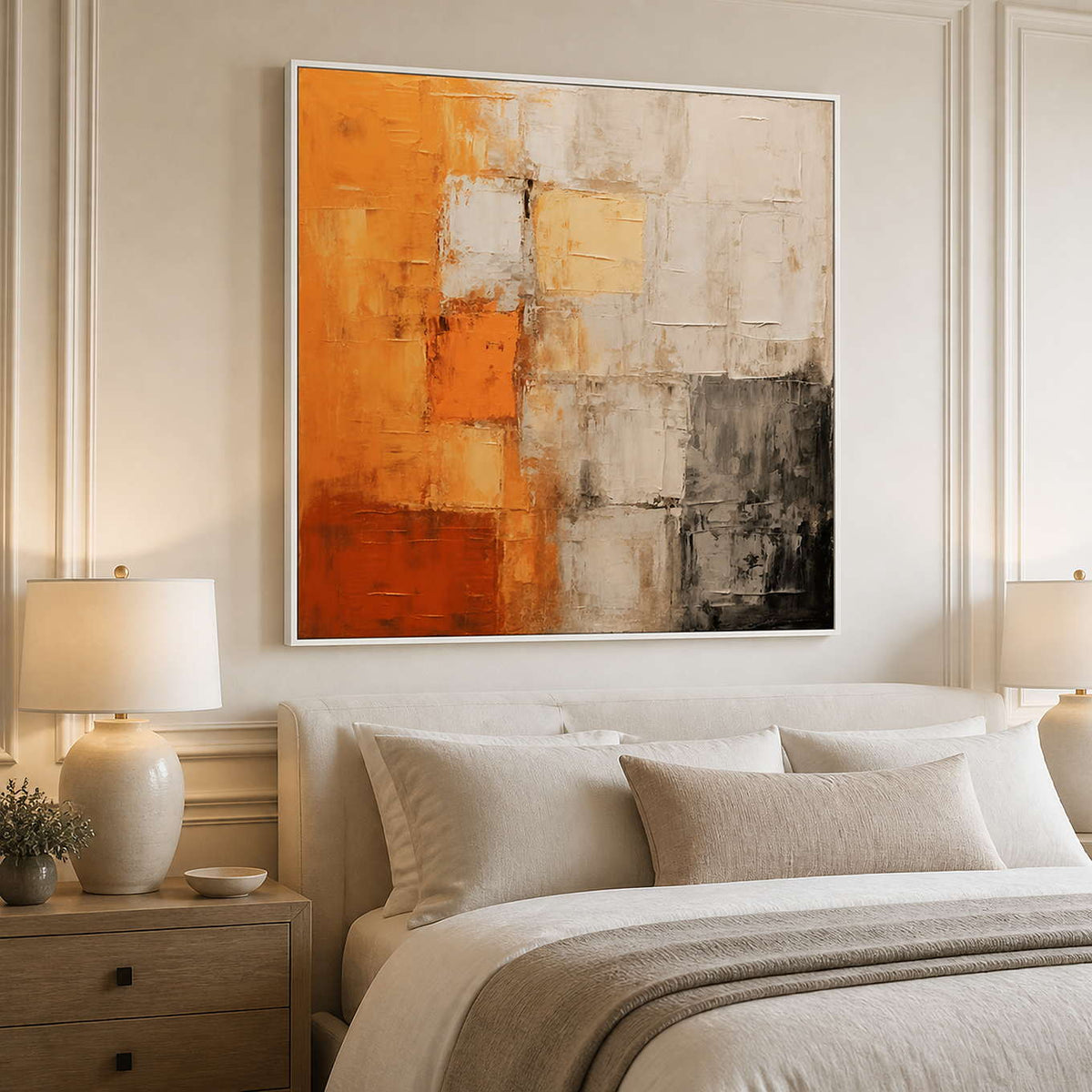 White framed warm abstract wall art above a neutral upholstered bed.