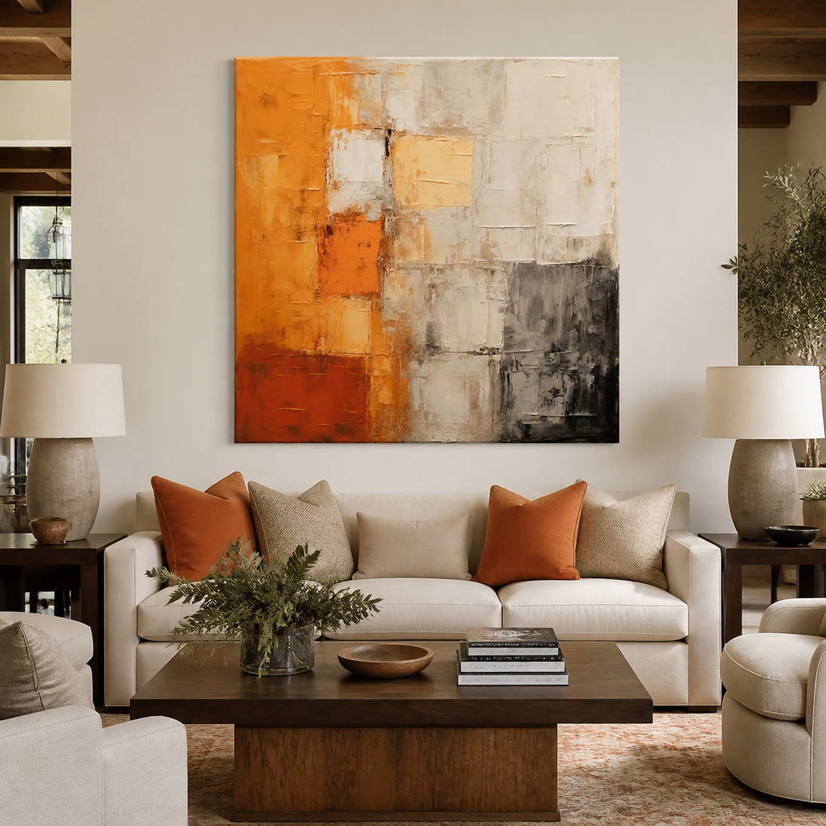 Orange and cream abstract wall art above a sofa with rust cushions.