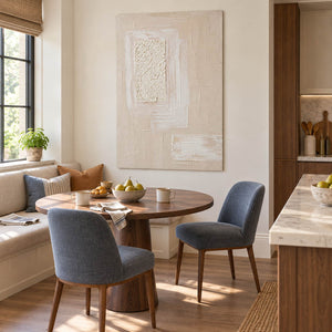 Ivory and blush relief painting with layered rectangles and a rough central panel without an outer frame in a breakfast dining area.