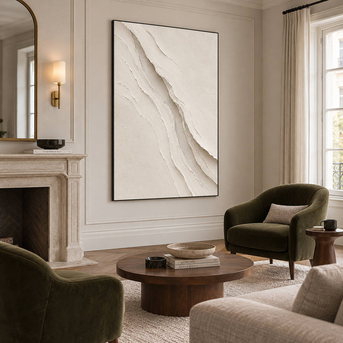 Hand-painted ivory abstract wall art with layered cream palette-knife relief, displayed beside or above a fireplace in a black frame.