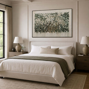 Soft green botanical wall art in a calm bedroom.