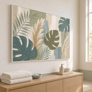 Sage leaves and ivory pampas grasses painting in a white frame beside a bathroom vanity.